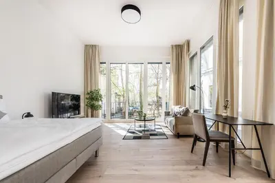 a bedroom with a bed and a table and a couch at DESIGN-STUDIO 1 !Gratis Parken, Free Parking! in Kreuzlingen