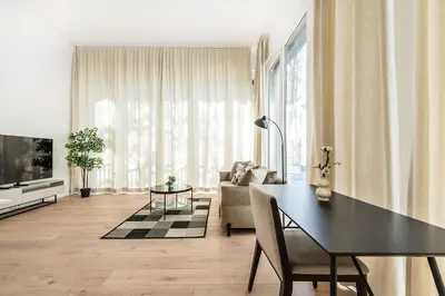 a living room with a black table and a couch at DESIGN-STUDIO 1 !Gratis Parken, Free Parking! in Kreuzlingen