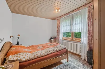 a bedroom with a bed and a window at Chalet Thur in Unterwasser