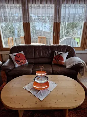 a coffee table in a living room with a brown couch at Chalet Thur in Unterwasser