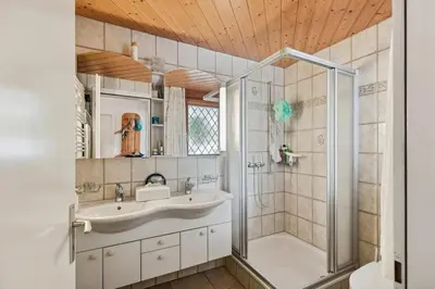 a bathroom with a sink and a shower at Chalet Thur in Unterwasser