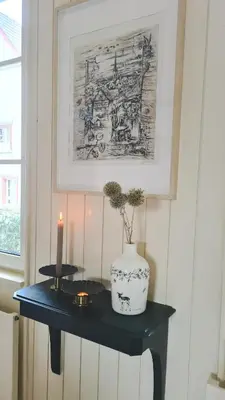a black table with a candle and a vase on it at Kaffeegasse 11 - Holiday home with heart on Lake Constance in Altnau