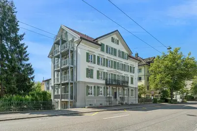 a large white building on the side of a street at Klara 0002 - Olma, Spital, Uni St- Gallen in St. Gallen
