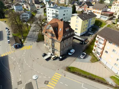 an old building with a red roof in a city at Private Apartment in Degersheim