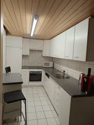 a kitchen with white cabinets and a sink at Como apartamento en el centro de st Gallen in St. Gallen