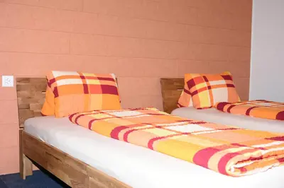 two beds with colorful blankets and pillows on them at Towerhotel in Waldkirch