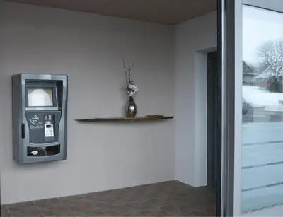 a atm machine with a vase on a wall at Towerhotel in Waldkirch