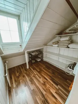 a attic room with a window and wooden floors at Central city apartment with terrace in St. Gallen