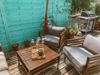 a patio with two chairs and a coffee table at Central city apartment with terrace in St. Gallen