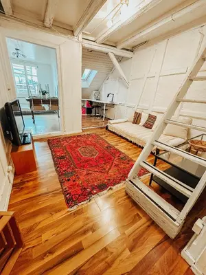 a room with two bunk beds and a rug at Central city apartment with terrace in St. Gallen