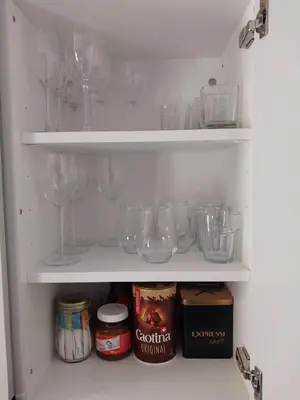 a refrigerator filled with wine glasses and other items at schickes gemütliches Studio in Bühler