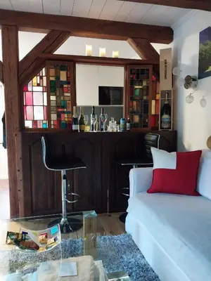 a living room with a couch and a bar at schickes gemütliches Studio in Bühler