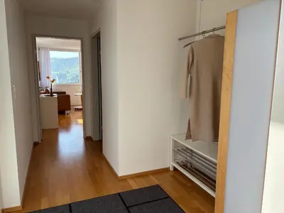 a hallway with a white wall and a closet at Appenzellerland, 2 Zimmer Ferienwohnung mit Aussicht in Haslen