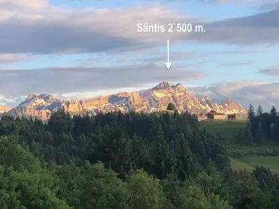 a mountain in the distance with a sign that reads starts m at Appenzellerland, 2 Zimmer Ferienwohnung mit Aussicht in Haslen