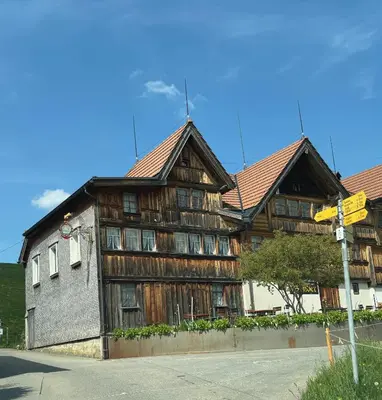 a large wooden building with two floors at Appenzellerland, 2 Zimmer Ferienwohnung mit Aussicht in Haslen