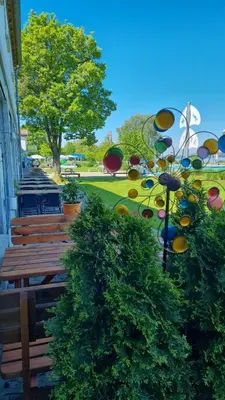 a group of benches sitting next to a park at Herberge Seeperle Bistro Rorschach in Rorschach