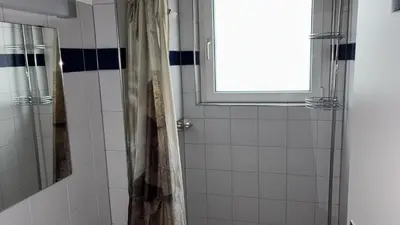 a bathroom with a shower and a window at Herberge Seeperle Bistro Rorschach in Rorschach