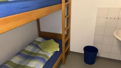 a bunk bed with a pillow on the bottom bunk at Herberge Seeperle Bistro Rorschach in Rorschach