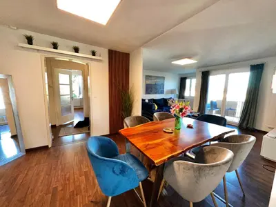 a dining room with a table and chairs at Modern Lakeview Apartment in Romanshorn