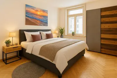 a bedroom with a large bed and a window at OLMA Center Barrock Suites in St. Gallen