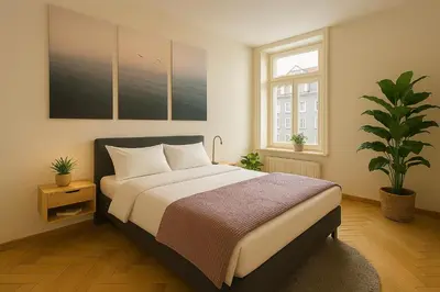 a white bathroom with a sink and a shower at OLMA Center Barrock Suites in St. Gallen