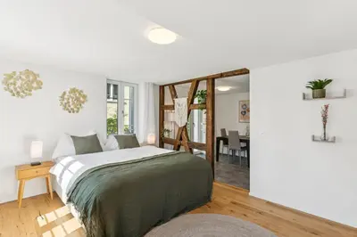 a bedroom with a bed and a dining room at Klara 1014 - Olma, Spital, Uni St- Gallen in St. Gallen
