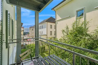 a balcony with a bench and buildings at Klara 1014 - Olma, Spital, Uni St- Gallen in St. Gallen