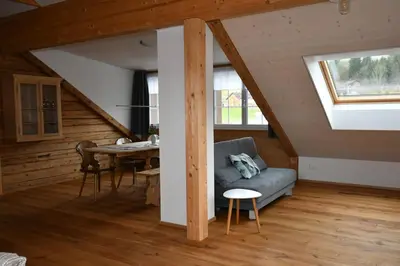 a living room with a couch and a table at Haus Ritzlisjokes in Weissbad
