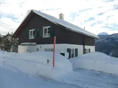 a house with a pile of snow in front of it at Wenk Elisabeth in Wildhaus