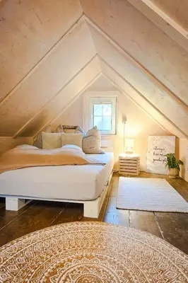 a bedroom with a large bed in the attic at Zum Wöschhüsli mit Sauna in Rheineck