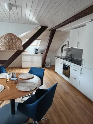 a kitchen and dining room with a table and chairs at Bijou petit -mit Terrasse in Rorschach