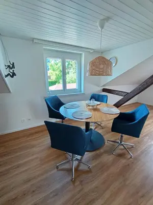 a dining room with a table and chairs at Bijou petit -mit Terrasse in Rorschach