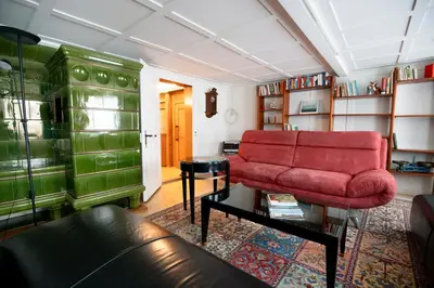 a living room with a red couch and a table at Wohnhaus Münzmühle in Appenzell in Appenzell