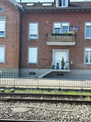 a brick building with windows with potted plants at S-Cape Suite&Spa in Horn