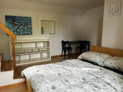 a bedroom with a bed and a table in it at Zimmer am See in Goldach