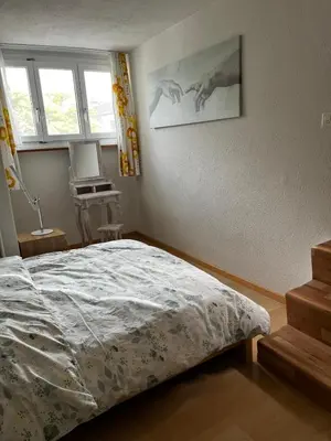 a bedroom with a bed and a window at Zimmer am See in Goldach