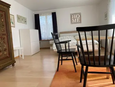 a room with two chairs and a table and a bed at Zimmer am See in Goldach