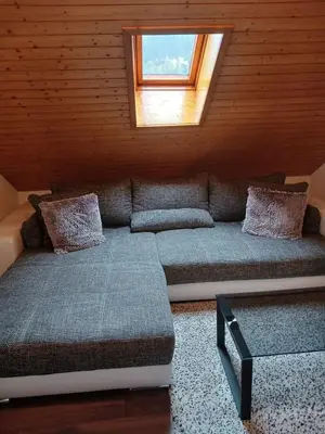 a living room with a couch and a window at 2,5 Zimmer Ferienwohnung in Bühler, Nähe Appenzell in Bühler