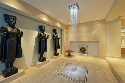 a chandelier hanging from a ceiling in a room at Villa Philipp Plein - Designervilla mit Pool in Amriswil