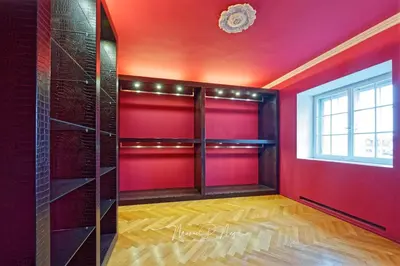 a bathroom with a tub and a sink and a red door at Villa Philipp Plein - Designervilla mit Pool in Amriswil