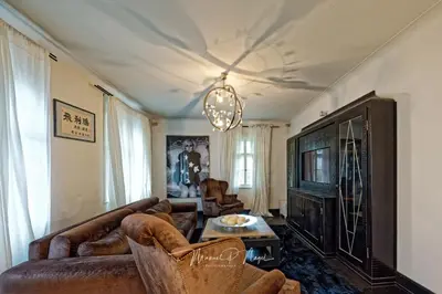 a living room with a couch and a tv at Villa Philipp Plein - Designervilla mit Pool in Amriswil