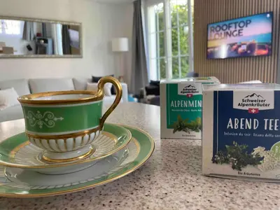a cup and a plate on a counter next to a box at Traumwohnung in 3 Minuten zum Bodensee in Dozwil