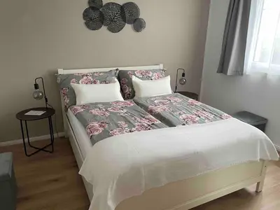 a bedroom with a large bed with flowers on it at Traumwohnung in 3 Minuten zum Bodensee in Dozwil