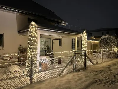 a house with christmas lights on the side of it at Traumwohnung in 3 Minuten zum Bodensee in Dozwil