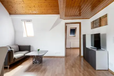 a living room with a couch and a tv at Private Apartment in Degersheim