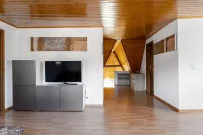 a large living room with a flat screen tv at Private Apartment in Degersheim