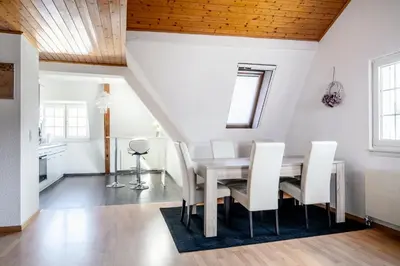 a dining room with a table and chairs at Private Apartment in Degersheim