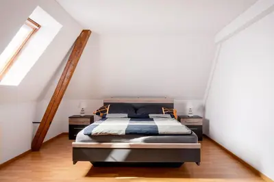 a bedroom with a bed and two night stands at Private Apartment in Degersheim