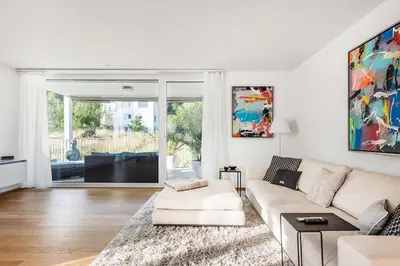 a white living room with a couch and a table at DESIGN-APARTMENT 2 !Gratis parken, Free Parking! in Kreuzlingen