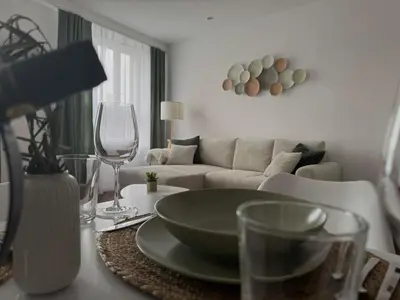 a living room with a couch and a table at Modern Apartment St Gallen Zentrum in St. Gallen